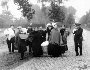 Refugees Prints: World War One - Refugees walk along the road carrying their possessions after fleeing