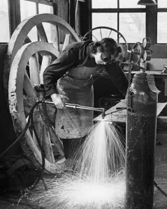Factory Worker Prints: World War Two, Grace Shults at a welding smiths work assembling farm wagons at Great