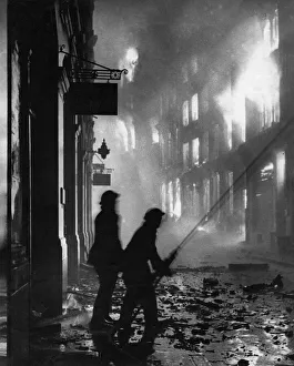 00036 Prints: World War Two. London Fire Service fighting a burning building after a bombing raid by