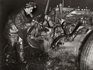 World War Two. Mrs M Bryan dressed in protective clothing cleaning dirt