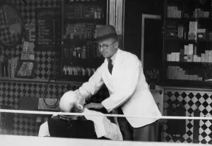 Morning Prints: World War Two. Wales. The hairdresser carries on with his business