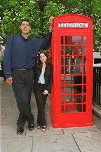 Weird Prints: Worlds tallest man Radhouane Charib in London May 1999 at 7ft 9inches with Mirror