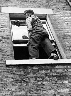 00177 Prints: A worried householder understood that sitting on the sill to clean the windows was