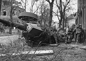 A wrecked German field gun provide a good firing point for troops of the 53rd Welsh