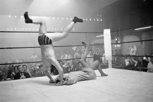 Wrestler jackie Pallo is thrown head over heels by Gigi Gattri during the filming of