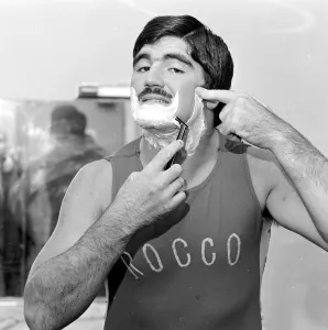Wrestler Prints: Wrestler Mark Rollerball Rocco seen here taking a shave before a bout November 1978
