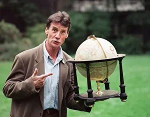 Writer and actor Michael Palin with a globe. 8th October 1992