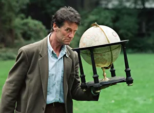 01223 Prints: Writer and actor Michael Palin with a globe. 8th October 1992