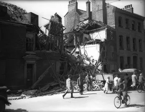 Baedeker Blitz Prints: WW2 Bomb Damage in York. People walking past the ruins of a building