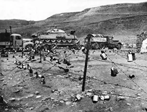 WW2 British tank transporter passes through an Italian wire defence in the Western Desert