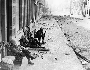 WW2 British troops in Louvain, Belgium take advantage of furniture left by refugees to