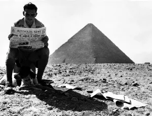 WW2 Corporal E Hopwood of Acton Wrexham reading the paper after casting his vote before