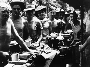 WW2 Crew of a 25 pounder on the Tiddim Road in Burma join the dinner queue L-R