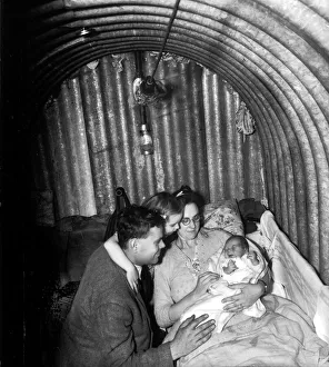 Shelter Prints: WW2 A family seeks refuge inside an Anderson Air Raid shelter during the blitz