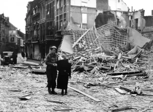 WW2 Invasion of France 1944 A soldier helps an elderly woman through