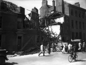 WW2 York Air Raid Bomb Damage Civilians walk pass bomb damaged housing in York as