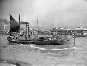 A Yarmouth Herring boat leaves the mouth of the River Yar Norfolk for a fishing trip in
