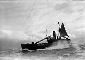 00086 Prints: A Yarmouth Herring boat ploughing through a moderate swell in the North Sea. Circa 1935