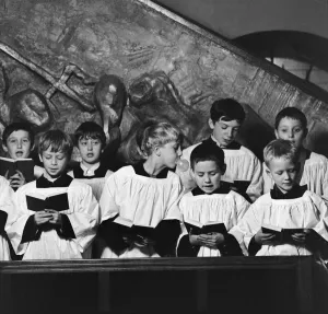 Ten year old choirboy Ian Stacey of Bethnal Green tries to break the concentration of his