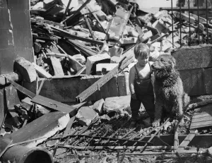 Three year old Freddy Arnold stands amongst the ruins of his bomb shattered home in Bath