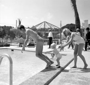 00170 Prints: Two year old Gregory Curtis with his mother Jill on holiday in Majorca pushing his dad