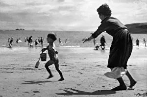 Shadow Prints: Three year old John Cromwell running away from his mother on the beach at Barry island