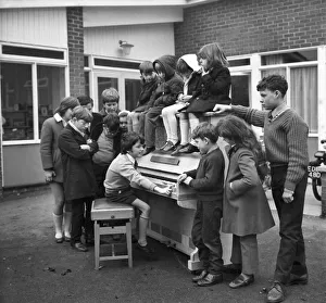 Eleven year old Martin Hawes entertains his school friends to a tune on the John Lennon
