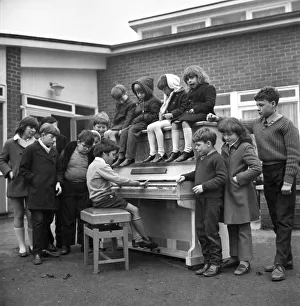 Donations Prints: Eleven year old Martin Hawes entertains his school friends to a tune on the John Lennon
