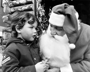 Santa Prints: Three year old Matthew whispers his Christmas wishes to Father Christmas
