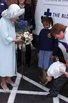 Humourous Prints: Four year old Nathan Goodwin bows to Queen Mother after presenting her with a bouquet of