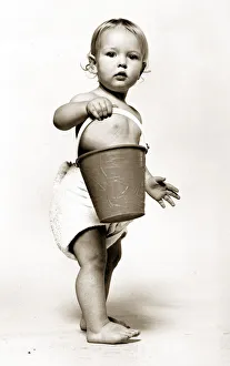 Bucket Prints: Four year old Oliver Cowley aged 18 months poses with a bucket as part of a horoscope