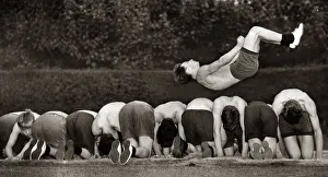 Excercise Prints: Fifteen year old Ronnie Laing leaping over a dozen of his colleagues in training for next