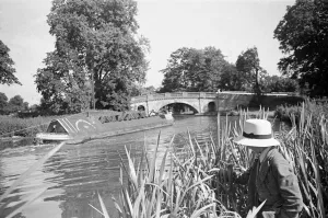 00089 Prints: A young angler wearing a panama hat fishing in the Grand Union Canal between