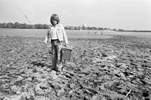 Heat Prints: Young boy goes for a spot of fishing at dried out Edgbaston reservoir in Birmingham