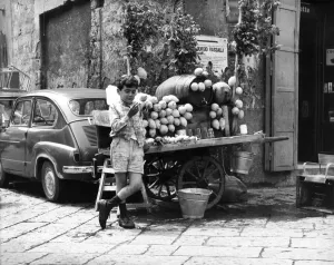 00050 Prints: A young boy of Naples in Southern Italy selling goods on the side of the road