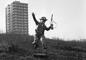 Images Dated 20th July 2021: Young boy playing cowboys in Collyhurst, Manchester 14th January 1968 His