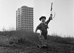00894 Prints: Young boy playing cowboys in Collyhurst, Manchester 14th January 1968 His