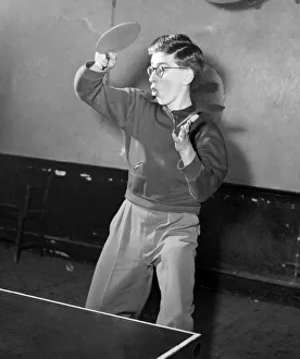 Young boy playing table tennis. January 1953 D232-001