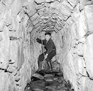 00177 Prints: A young boy poses in the Well of Heads'at Invergarry, Scotland circa 1960