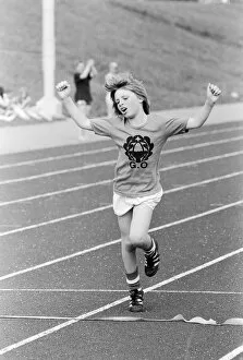 Images Dated 20th June 1979: A young boy raises his arms in celebration as he crosses the finish line to win the race