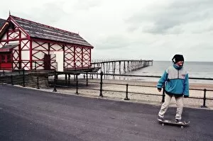 00686 Collection: A young boy skateboarding past Saltburn pier, North Yorkshire. 9th May 1996