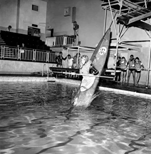 00033 Prints: Young boy takes a canoe of a 10 feet high diving board at Bournemouth swimming pool