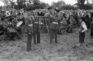 A young boy watching a military band playing during Canterbury Week, Kent