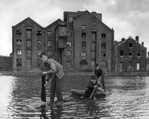 00170 Prints: Three young boys from Cardiff paddle across the old Cardiff West Dock on their homemade