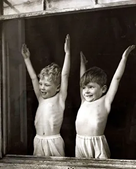 Nursery Prints: Two young boys doing stretching and breathing exercises in front of an open window