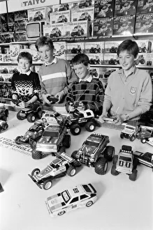 Toys Prints: Young boys playing with toy remote control cars in Hamley s, London