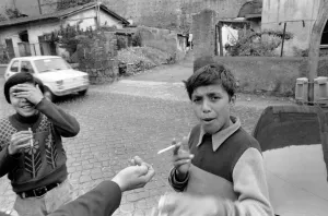 Suburban Prints: Two young boys on the streets smoking cigarettes in a poor suburb on the outskirts of