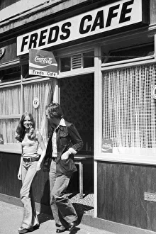 Young couple walking out of Freds cafe ineast London after finishing their lunch