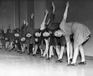 Exercises Prints: These young female workers in a North West factory are given physical training during