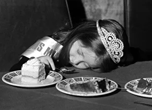 01228 Prints: A young girl fall asleep on the table whilst eating a peice of cake - Childrens